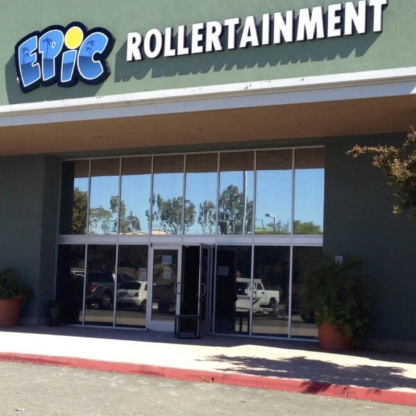 The exterior of the building, featuring "Epic Rollertainment" displayed above the entrance, showcases large glass windows and doors. The green facade at 39809 is flanked by two potted plants. Check out the Epic Rollertainment schedule for upcoming events!