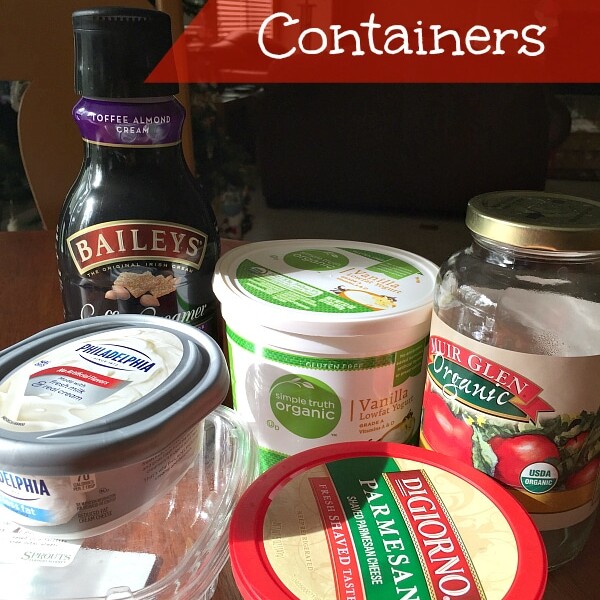 A variety of empty containers, including a Baileys coffee creamer bottle, a yogurt cup, a Philadelphia cream cheese tub, a jar of tomato sauce, and a DiGiorno Parmesan cheese container, are displayed on a table. The text "Repurposing Plastic Containers" is written on the image.