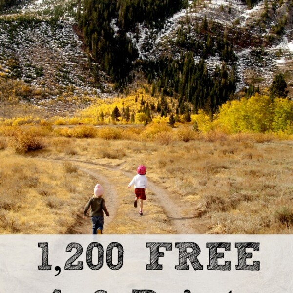 Two children are running on a dirt path towards distant snow-capped mountains and forested areas, under a clear sky. In the foreground, text reads "1,200 FREE 4x6 Prints Every Year from Snapfish!" in bold lettering.