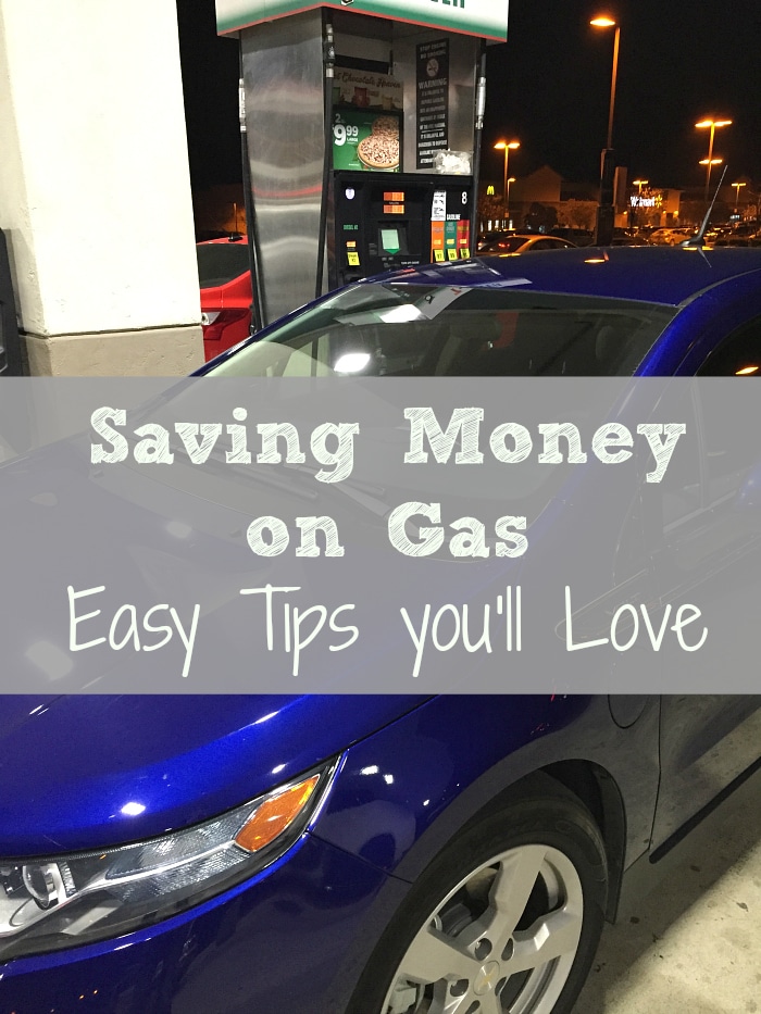 A blue car is parked at a gas station at night, with a gas pump in the background. Text overlay on the image reads, 