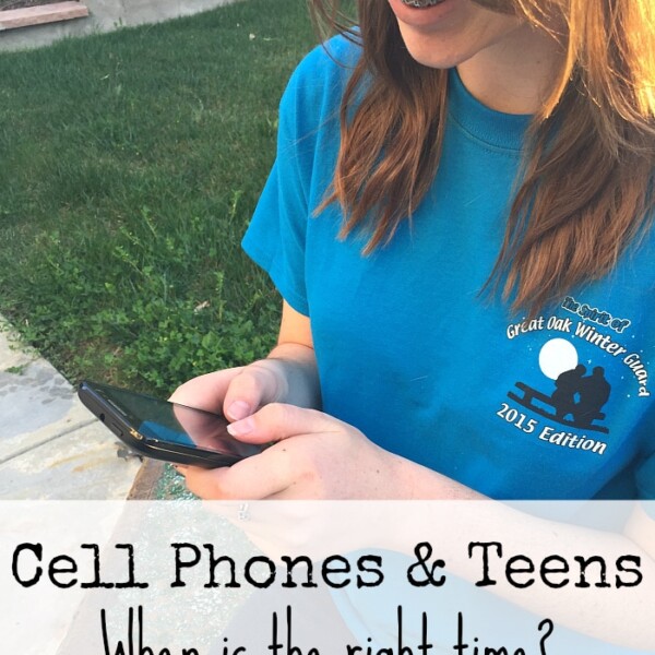 A teen smiles while using a smartphone outdoors, wearing a blue t-shirt. Text overlaid asks, "Cell Phones & Teens: When is the right time for the best first cell phone for tweens?