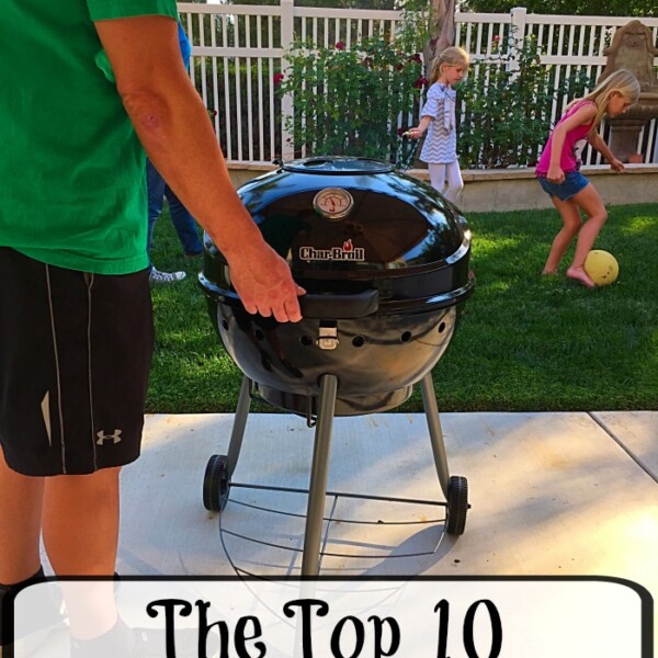 A person stands by a charcoal grill outdoors, mastering the top 10 barbeque hacks, while children play with a ball on the grass.