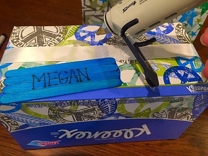 Repurposing a kleenex box into a box to organize school supplies.