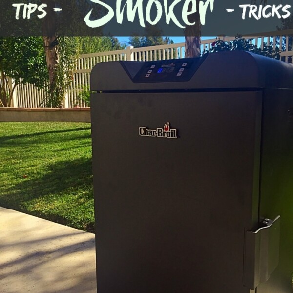 An outdoor scene showcases a Char-Broil smoker on a patio, with text reading Tips - Smoker - Tricks. In the background, a grassy lawn, trees, and white fence complement the view as the sun casts long shadows. Discover electric smoker recipes to elevate your next grilling adventure.