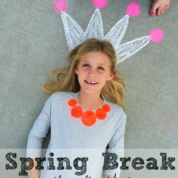 Girl lying on concrete with a chalk crown drawn above her head, wearing an orange necklace. Discover the best spring break staycation ideas to make your time at home unforgettable!