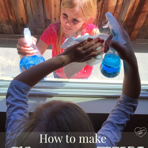 Two children clean a window from opposite sides using spray bottles and cloths, with text overlay: Making chores fun for kids.