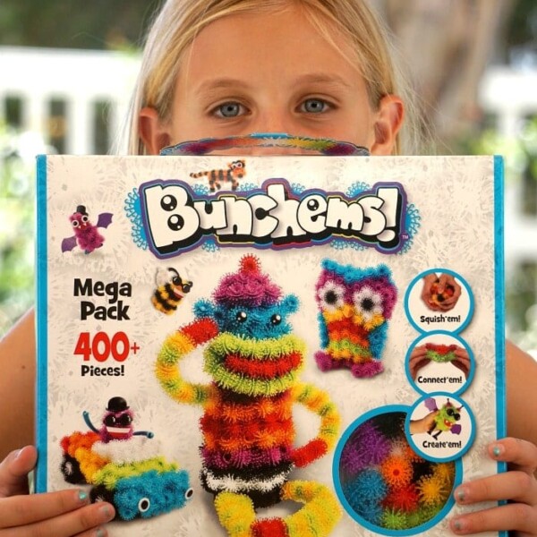 A child excitedly holds a Bunchems Alive Mega Pack, showcasing the colorful and creative toys on the box.