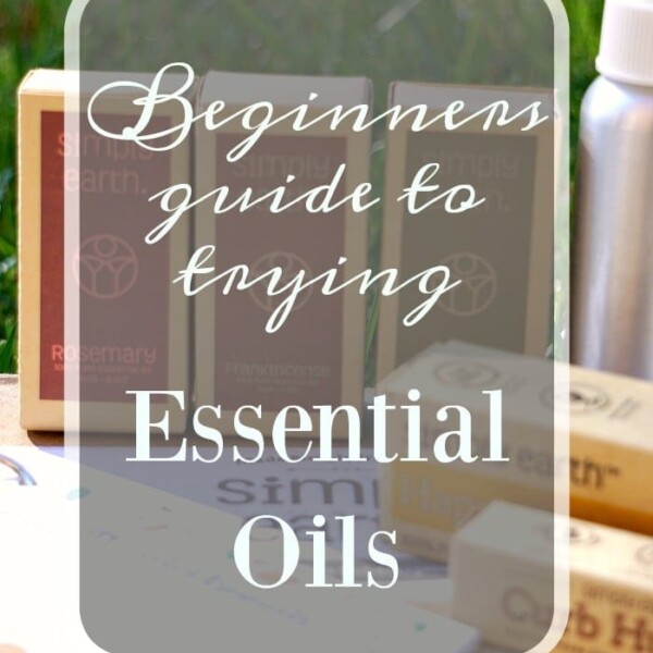 Essential Oils 101: A beginner's guide featuring bottles elegantly displayed on a lush grass background.