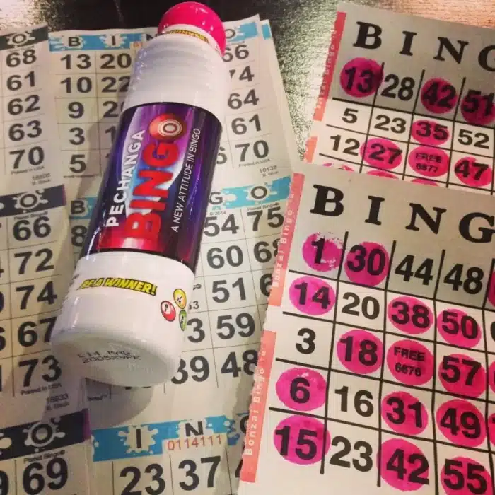 Rows of pink-marked numbers stretch across the bingo cards, while a "Pechanga Bingo" dauber rests on top, ready for action.