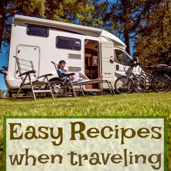 A person unwinds by an RV nestled in a forest, while bikes rest nearby. Explore easy RV meals with our travel recipes that make your outdoor experience delicious and stress-free.