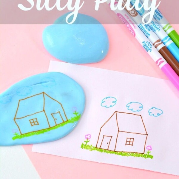 Silly Putty craft on pink paper, enhanced with colorful markers, showcases a whimsical drawing of a house crafted using the putty. Discover how to make Silly Putty and unleash your creativity.