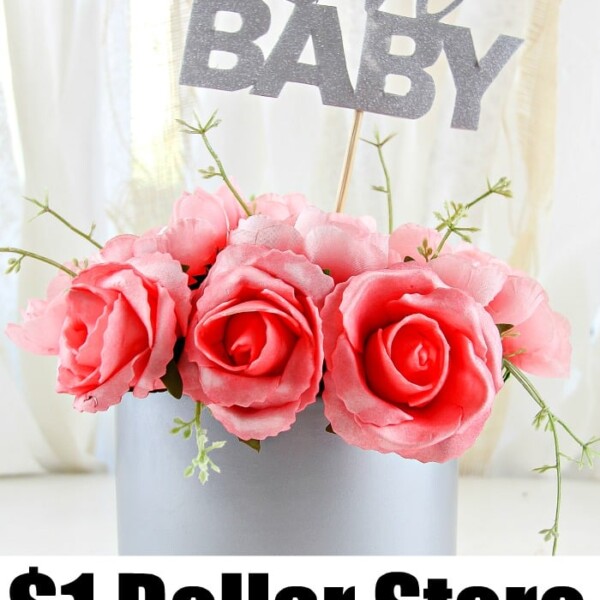 A charming DIY baby shower decorating idea includes a decorative arrangement featuring pink roses in a gray pot, topped with a glittery Oh BABY sign. The text at the bottom reads $1 Dollar Store baby shower decor.