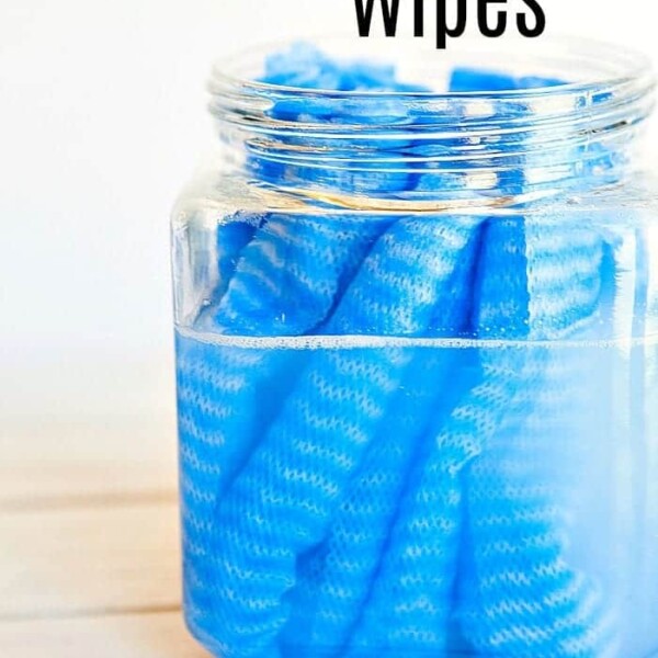 A jar of DIY cleaning wipes rests on a wooden surface, exuding a touch of homemade charm. Text above proudly announces: DIY Cleaning Wipes.