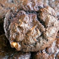 Close-up of homemade chocolate muffins stacked on top of each other, a delightful twist on classic zucchini dessert recipes.