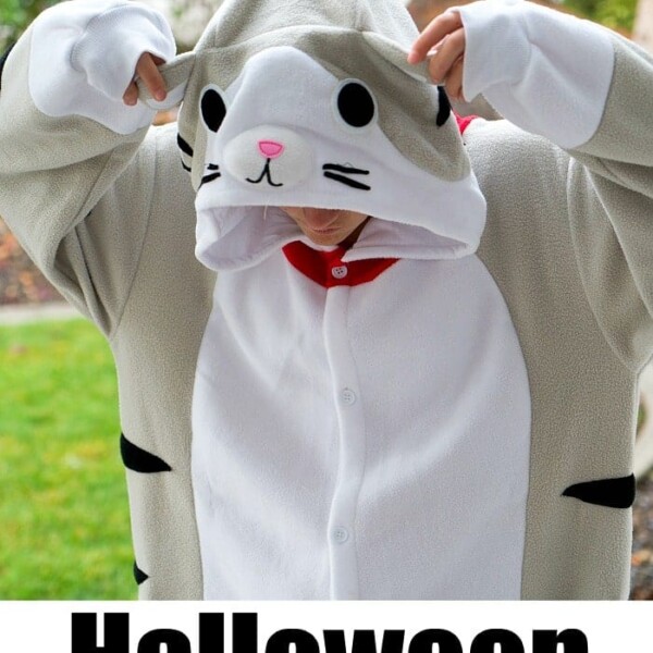 Teen in cat onesie adjusts hood outdoors; text reads Halloween Safety Tips for Teens.