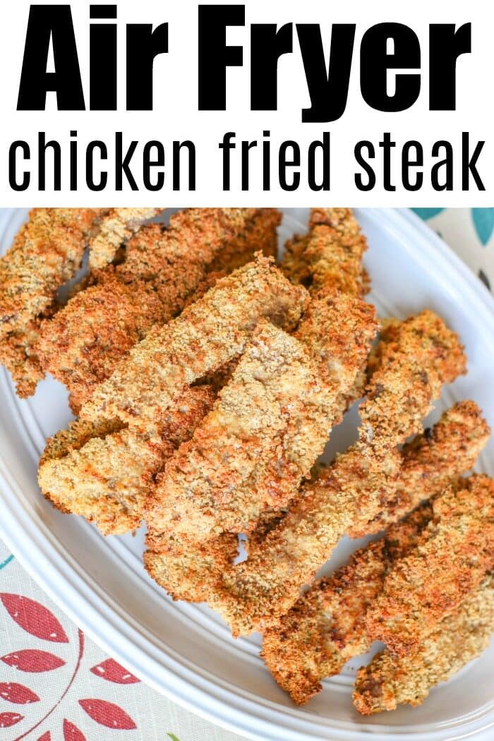 Crispy air fryer chicken fried steak strips are arranged on a white oval plate, showcasing the perfect golden-brown crunch.