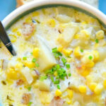 A bowl of creamy instant pot potato corn chowder with a spoon.