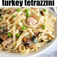 Plate of creamy turkey tetrazzini with fettuccine, peas, and mushrooms. Text reads: Easy Instant Pot recipe for delicious turkey tetrazzini.