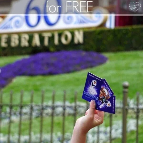 A hand clutching Disneyland tickets catches the eye as a 60th celebration sign gleams in the background, hinting at the magic of how to get into Disneyland for free.