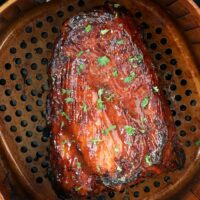 Succulent ribs glazed with herbs are perfectly cooked in a Ninja air fryer, then placed in a perforated pan.