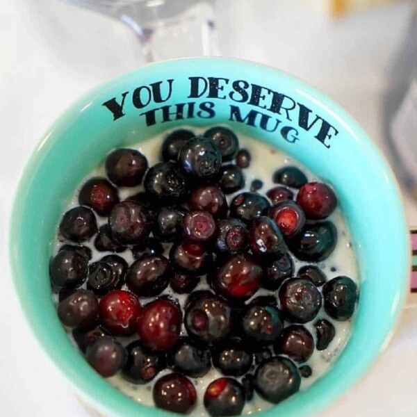 Blueberries in a teal mug make for the perfect topping to your simple overnight oats with yogurt.