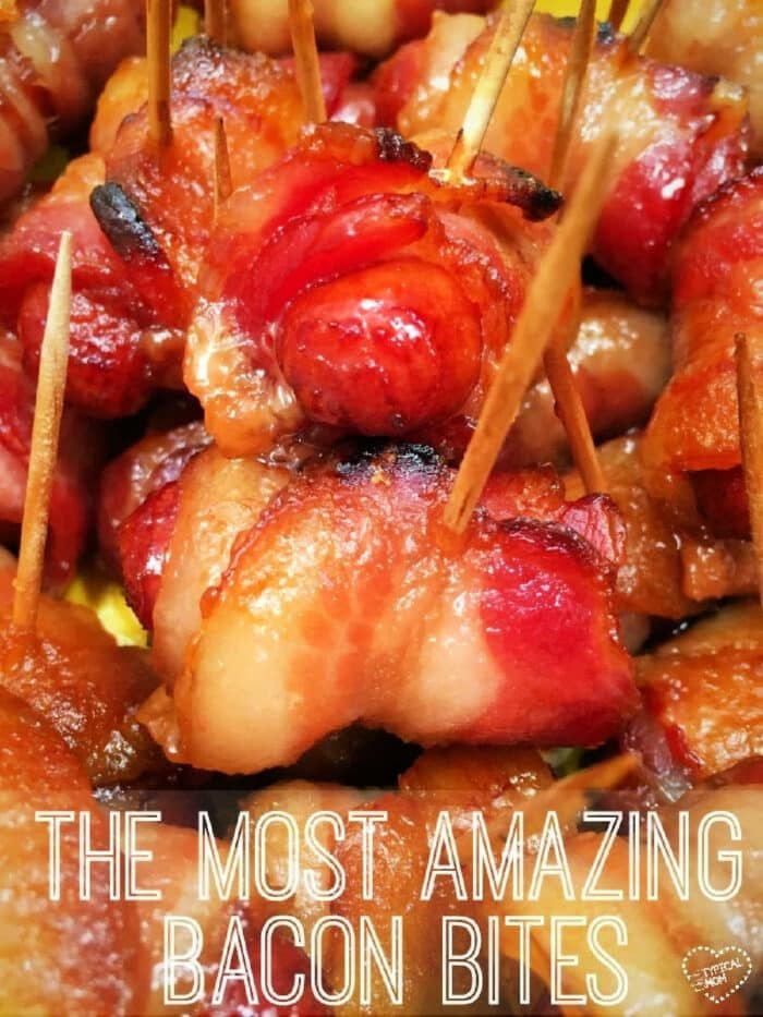 Close-up of bacon-wrapped hot dogs with brown sugar, secured with toothpicks, text overlay reads The Most Amazing Bacon Bites.