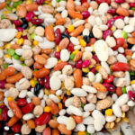 A colorful assortment of various beans and legumes, perfect for cooking in a pressure cooker to enhance their flavors and textures.