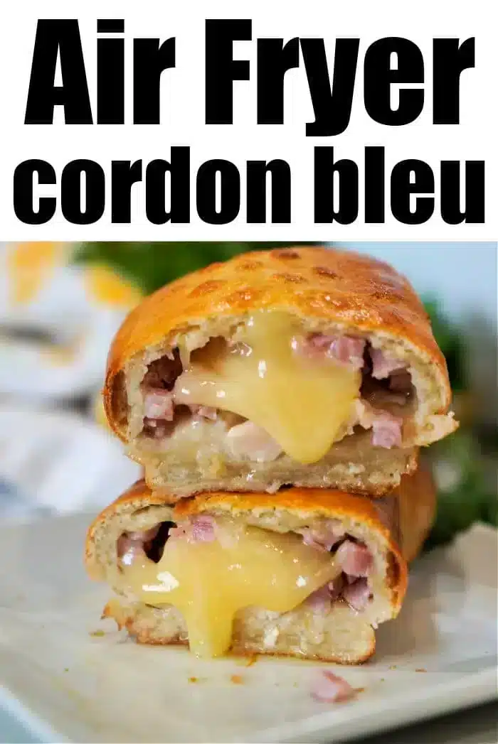 A close-up of an air fryer chicken cordon bleu, sliced in half to reveal melted cheese and pieces of ham nestled within a golden-brown crust. The text above reads "Air Fryer Chicken Cordon Bleu." The dish is elegantly presented on a white plate.