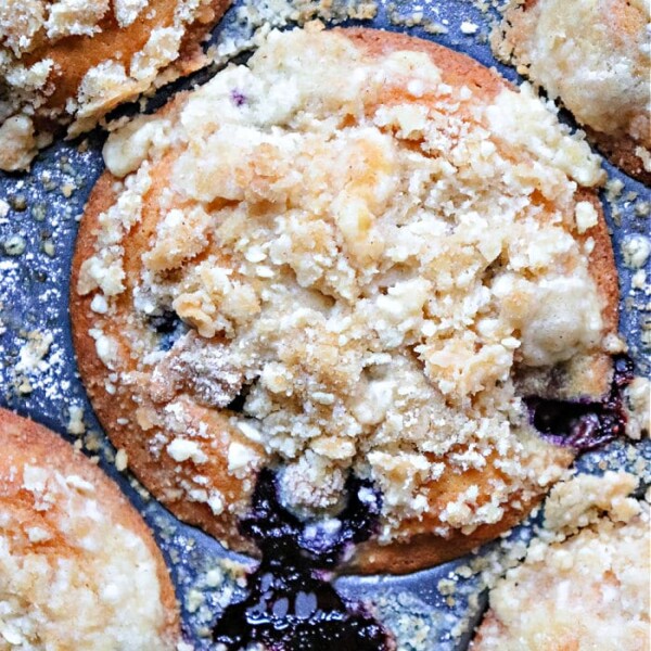 Close-up of blueberry muffins with a crumb topping for muffins, beautifully baked in a metal muffin tray.