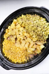 A crockpot brimming with corn, lima beans, diced potatoes, and zesty seasonings creates a delicious riff on Brunswick stew.