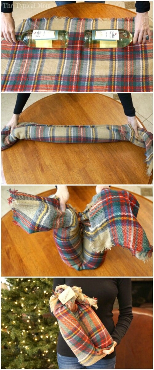 A step-by-step guide on how to gift wine bottles in a scarf: lay the bottles on a plaid blanket, roll them snugly, twist the ends securely, and fold upwards. The final image shows a person proudly holding the wrapped bottles by a decorated Christmas tree.