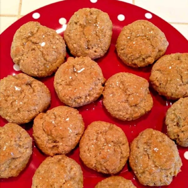 Lebkuchen cookies on a red polka-dot plate, drizzled with honey.