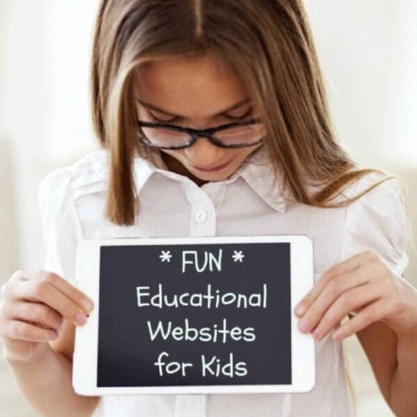 A girl with glasses is holding a tablet displaying the text: *FUN* Free Educational Websites for Kids. She looks down at the screen, wearing a white shirt, as her curiosity and excitement shine through.