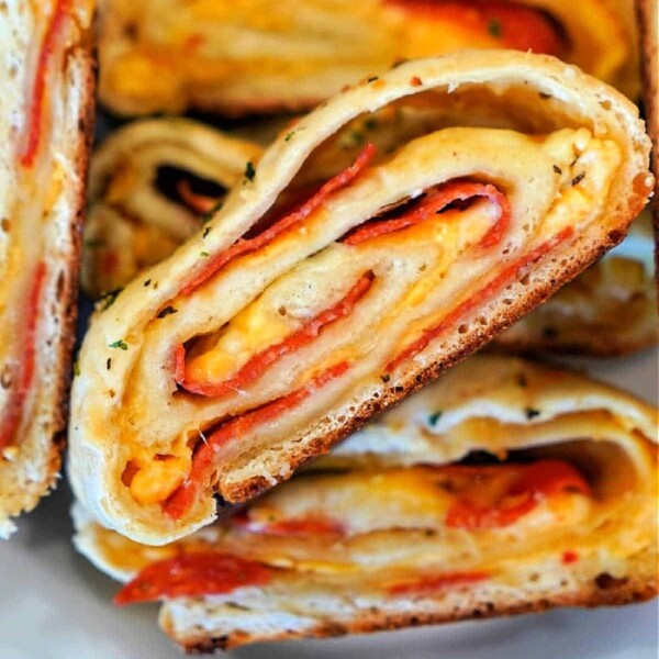 Close-up of sliced stromboli with layers of dough, melty cheese, and savory pepperoni, reminiscent of a perfectly crafted Traeger pizza.