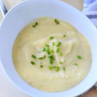 A bowl of creamy mashed potatoes topped with chopped chives brings the comforting essence of an Instant Pot Potato Leek Soup to your table.