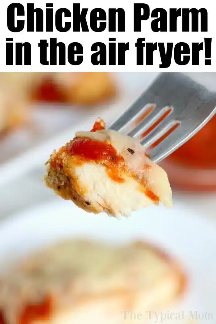 A fork holds a piece of air fryer chicken parm with red sauce and melted cheese. Text at the top reads, "Chicken Parm in the air fryer!" A blurred background features more deliciously crisp chicken parm.