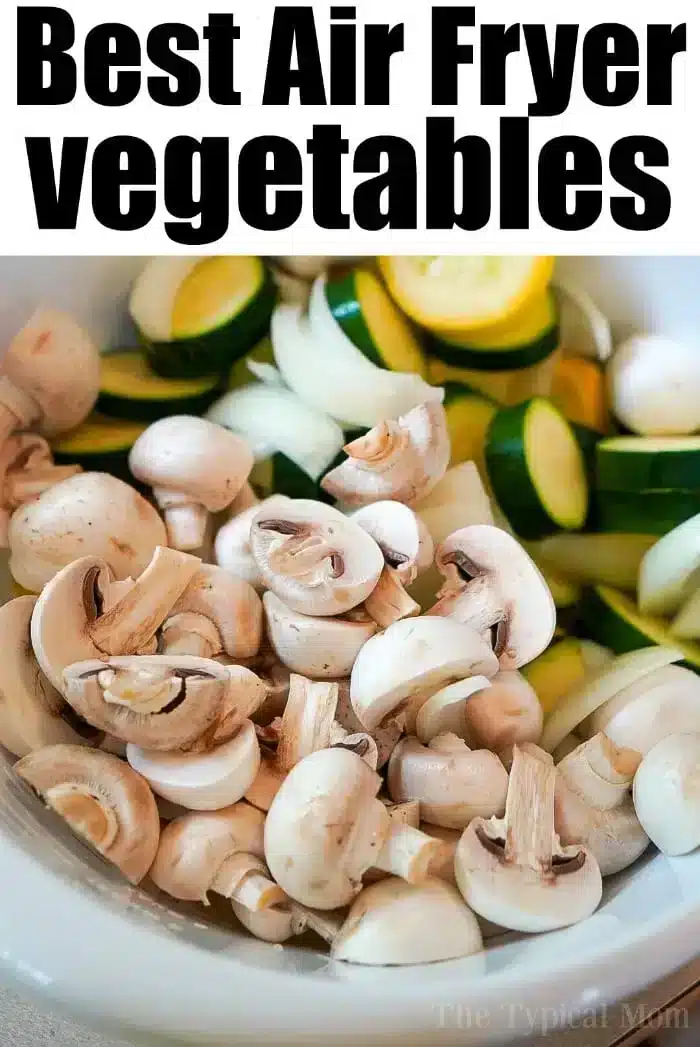 A white bowl brimming with air fryer vegetables like sliced mushrooms, zucchini, and onions. The text above reads, "Best Air Fryer Vegetables.