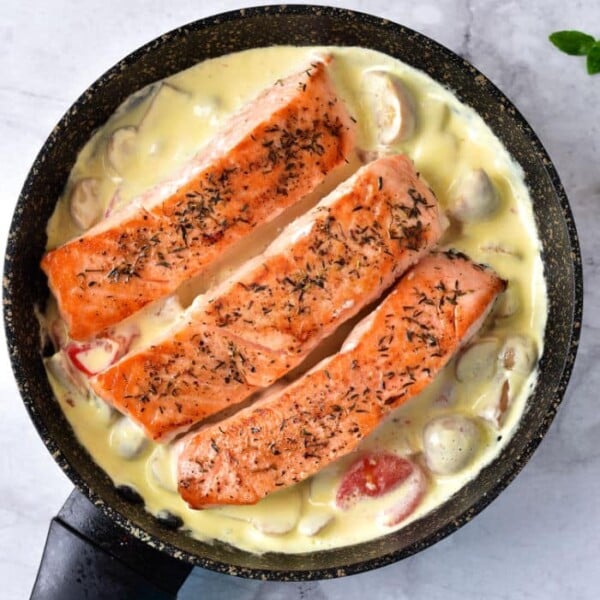Learn how to cook sockeye salmon with pan-seared fillets nestled in a creamy mushroom and tomato sauce, all perfected in a skillet.