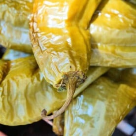 Close-up of roasted hatch chiles stacked together, perfect for spicing up your favorite hatch chile recipes.