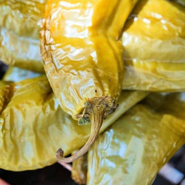 Close-up of roasted hatch chiles stacked together, perfect for spicing up your favorite hatch chile recipes.