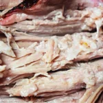 Close-up of a smoked pork roast with a dry rub, showcasing layers of tender, juicy meat encased in a crispy exterior. Bold text above highlights "Smoked Pork Roast" while the bottom subtly emphasizes "with dry rub.