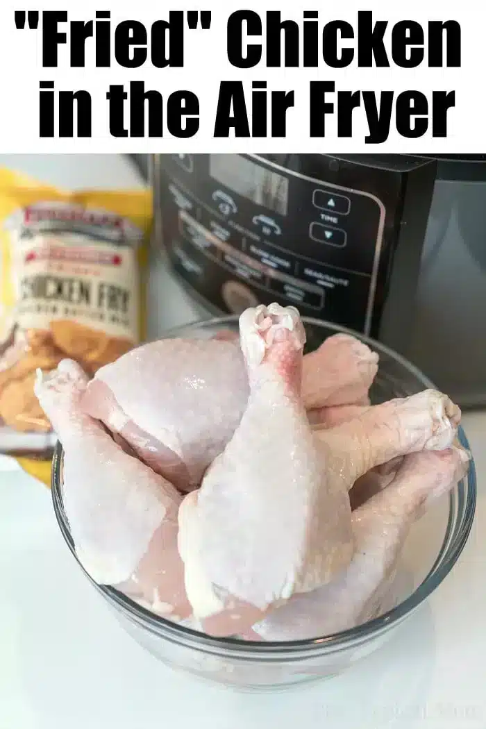 A glass bowl filled with raw chicken drumsticks is placed in front of an air fryer. A package labeled "Chicken Fry" is visible in the background. The text at the top of the image reads, "'Fried' Chicken in the Air Fryer: Your Ultimate Air Fryer Fried Chicken Recipe.