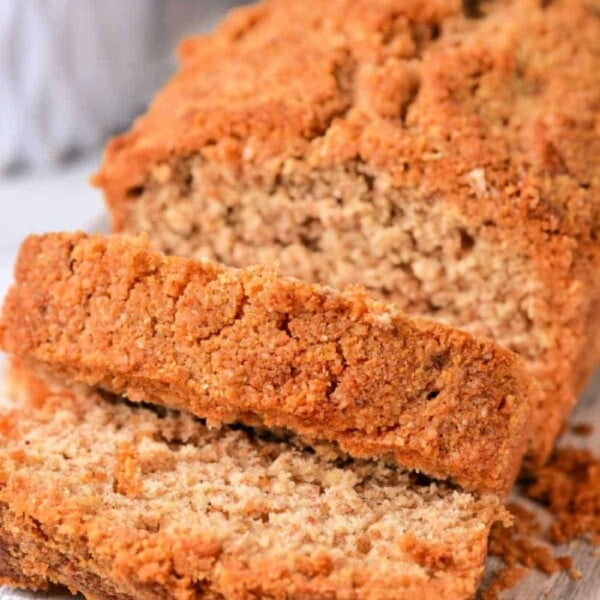 Close-up of sliced coffee cake with a crumbly brown crust on a wooden surface, resembling a healthy coffee cake.