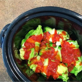 Slow cooker stuffed cabbage rolls are drenched in savory tomato sauce, blending flavors beautifully.