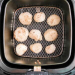 Air fryer scallops are seasoned with pepper and arranged in a single layer inside the air fryer basket for perfect, tender results.