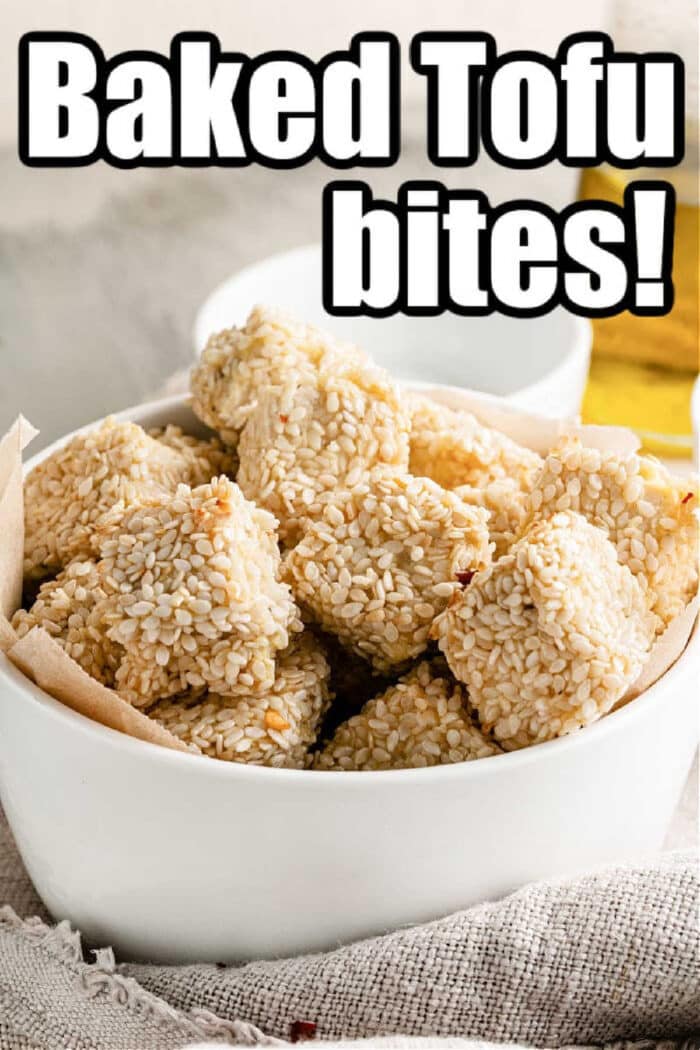 A bowl of sesame-coated tofu nuggets exudes a crispy allure, adorned with bold text: Baked Tofu Bites!