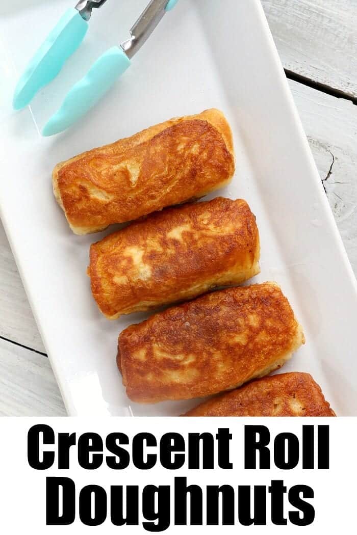 A white rectangular plate holds four golden-brown crescent roll doughnuts. A pair of tongs with turquoise handles is placed at the top of the plate. The text at the bottom of the image reads "Peanut Butter and Jelly Crescent Roll Doughnuts.