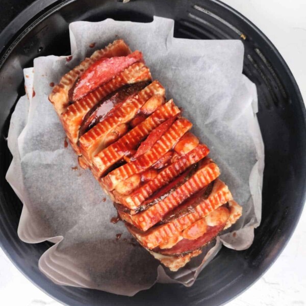 A loaf of halloumi cheese sliced and cooked in the air fryer