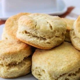 A plate of freshly baked Crisco Biscuits stacked on a white dish.