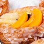 Close-up view of puff pastry Danishes topped with fruit slices and a light sugar glaze. The pastries are arranged on a white sheet. "Puff Pastry Danishes" is prominently displayed at the top of the image, showcasing one of the delectable puff pastry breakfast recipes.